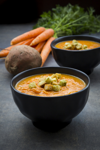 Bowl of sweet potato carrot soup with croutons stock photo