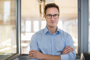 Portrait of confident young businessman in office - DIGF03320