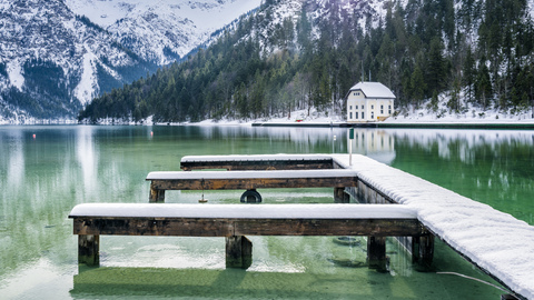 Austria, Tyrol, Ammergau Alps, Lake Plansee in winter, mooring area stock photo