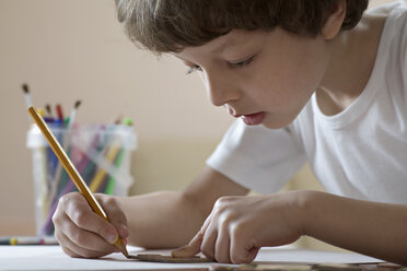 A boy drawing with a pencil - FSIF00472