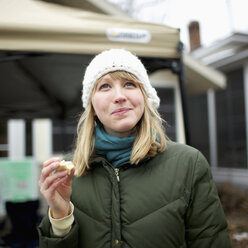 Porträt einer Frau in Winterkleidung, die den Blick abwendet - FSIF00570