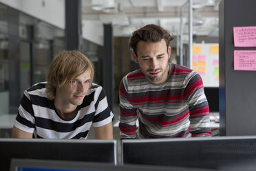 Two men working on computer in office - FSIF00698