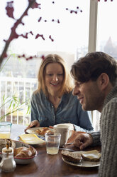 Couple having breakfast at dining table - FSIF00793