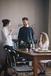Young man with female friends having breakfast at home - FSIF00833