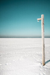 Wooden post on snowy landscape against clear sky - FSIF00985