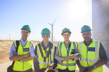 Portrait of four smiling engineers on a wind farm - ZEF14974