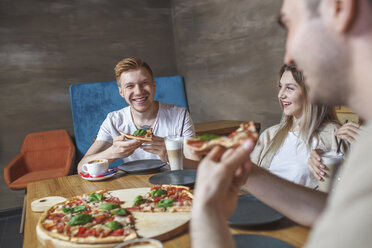 Friends enjoying pizza at restaurant - FSIF01168