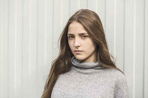 Portrait of teenage girl against white wall - FSIF01208