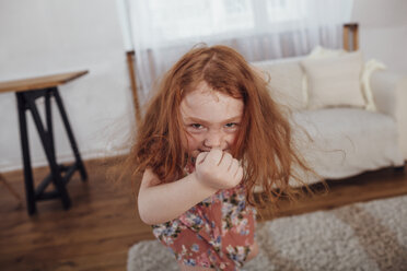 Portrait of happy girl dancing in living room at home - FSIF01227