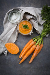 Glass of sweet potato carrot soup garnished with chives - LVF06695