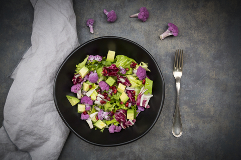 Mixed salad, purple cauliflower, avocado and pomegranate seeds stock photo