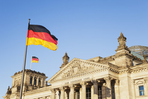 Germany, Berlin, Regierungsviertel, Reichstag building with German Flags - GWF05430