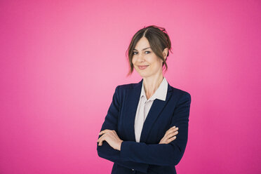 Portrait of confident businesswoman in front of pink wall - MOEF00849