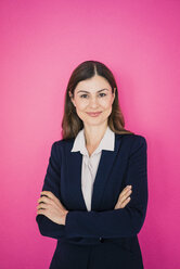 Portrait of confident businesswoman in front of pink wall - MOEF00850