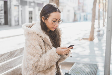 Stylish young woman in the city using cell phone - AFVF00019