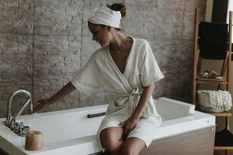 Young woman preparing a bath in a spa stock photo