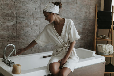 Young woman preparing a bath in a spa - OCAF00150
