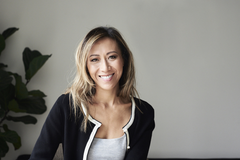 Portrait of smiling woman at home stock photo