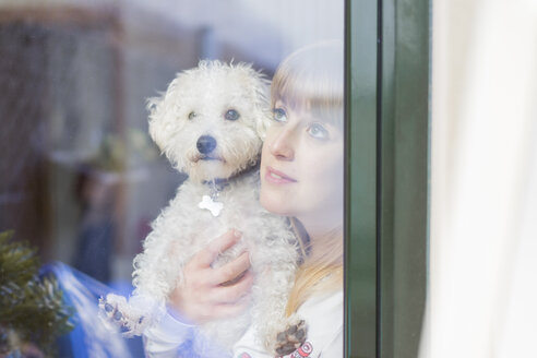 Frau und ihr Hund schauen aus dem Fenster - AFVF00088