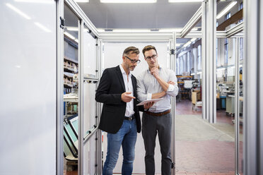 Two businessmen with tablet in factory - DIGF03336