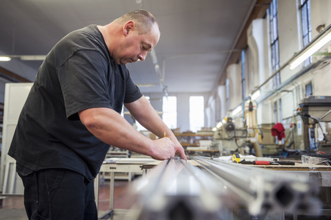 Man in factory working on metal component stock photo