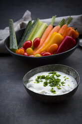Bowl of chive dip, cherry tomatoes and various vegetable sticks - LVF06718