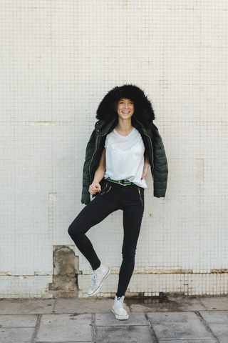 Laughing woman wearing hooded jacket stock photo