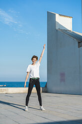 Portrait of smiling woman standing at sunlight - AFVF00104