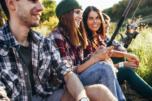 Happy friends fishing together in forest - FSIF01518