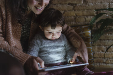 Mother and daughter using digital tablet at home - GEMF01885