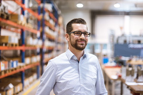 Portrait of smiling businessman in factory stock photo