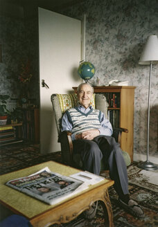 An old man sitting in a rocking chair in his living room - FSIF02008