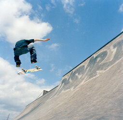 Man jumping in air with skateboard - FSIF02038