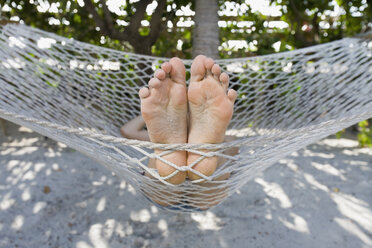 Close up of personís feet lying in hammock - FSIF02082