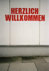 ËHerzlich Willkommení sign on building exterior - FSIF02088