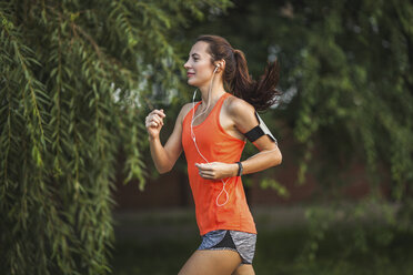 Side view of woman jogging at park - FSIF02227