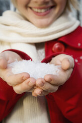 Young woman with a handful of snow - FSIF02337