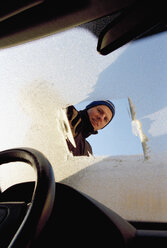 Man looking through frost covered windshield - FSIF02374