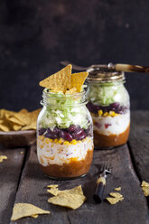 Taco salad, chili con carne, sour cream, corn, kidney beans, iceberg lettuce in a jar, nacho chips - SBDF03470