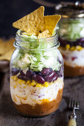 Taco salad, chili con carne, sour cream, corn, kidney beans, iceberg lettuce in a jar, nacho chips - SBDF03471