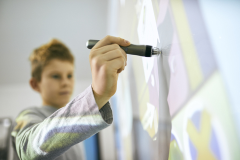 Student in class using digitized pen at interactive whiteboard stock photo