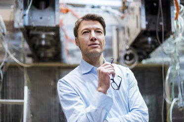 Portrait of confident businessman in factory - DIGF03410