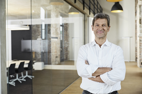 Portrait of confident businessman in modern office stock photo