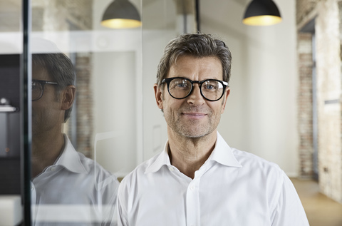 Portrait of smiling businessman wearing glasses stock photo