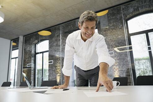 Businessman working with documents on desk in modern office - PDF01510