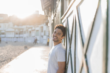 Portrait of happy young man on the beach at sunset - AFVF00140