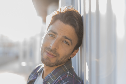 Portrait of young man on the beach at sunlight stock photo