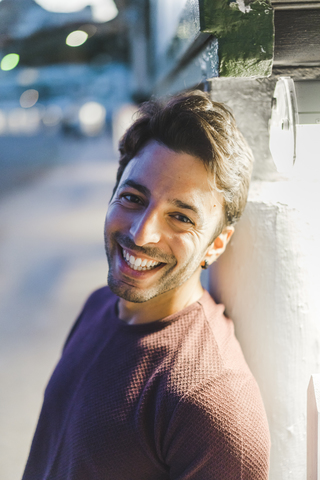 Portrait of laughing young man in the evening stock photo