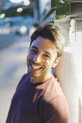 Portrait of laughing young man in the evening - AFVF00163