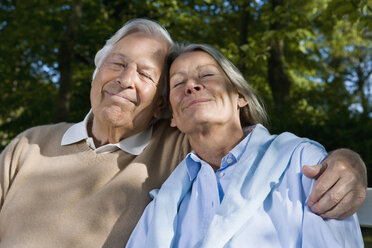 Ein älteres Paar sitzt zusammen auf einer Bank - FSIF02669